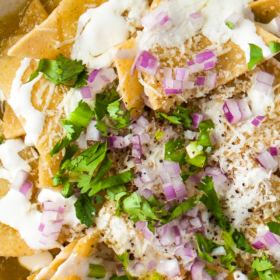 Chilaquiles Verdes topped with cheese, onion and cilantro.