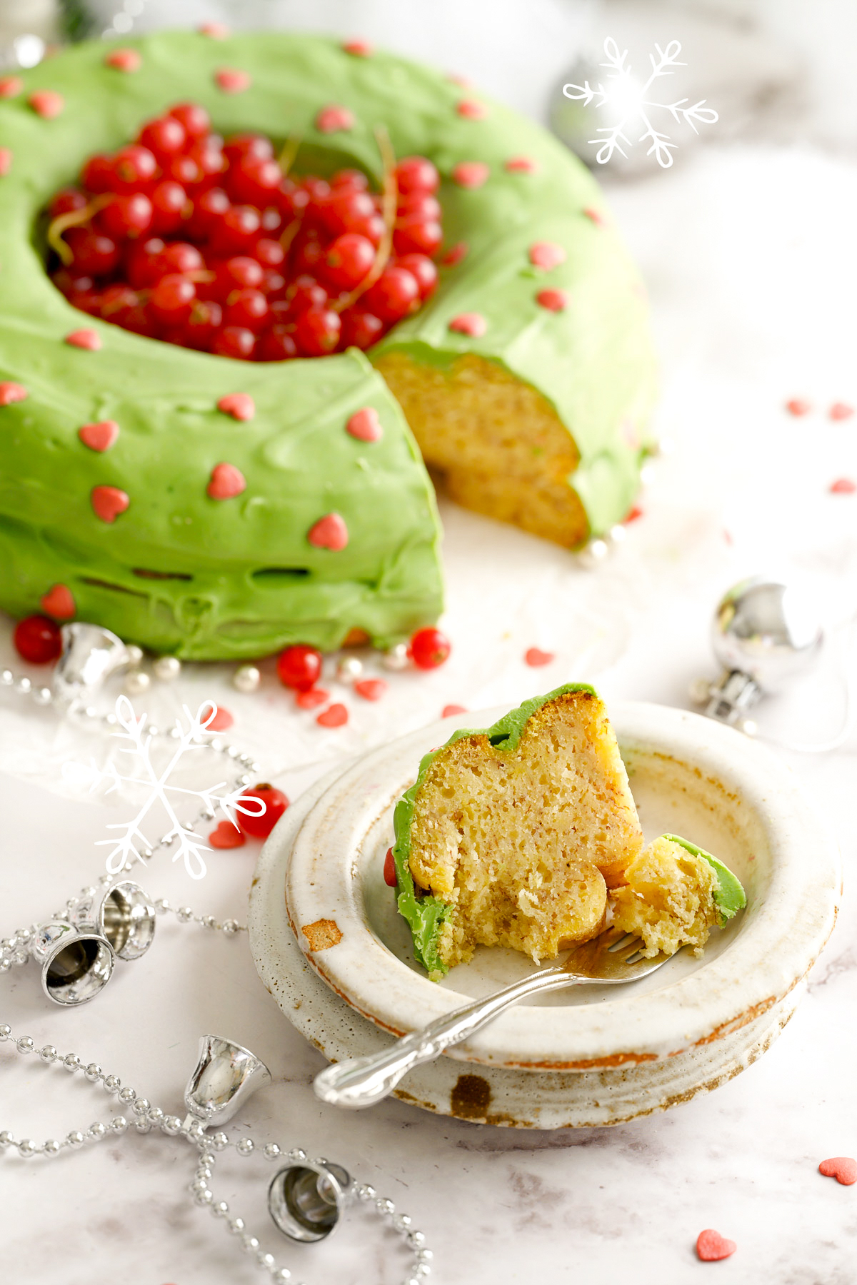 A Christmas banana cake with a small slice cut from it, served on a dessert plate.