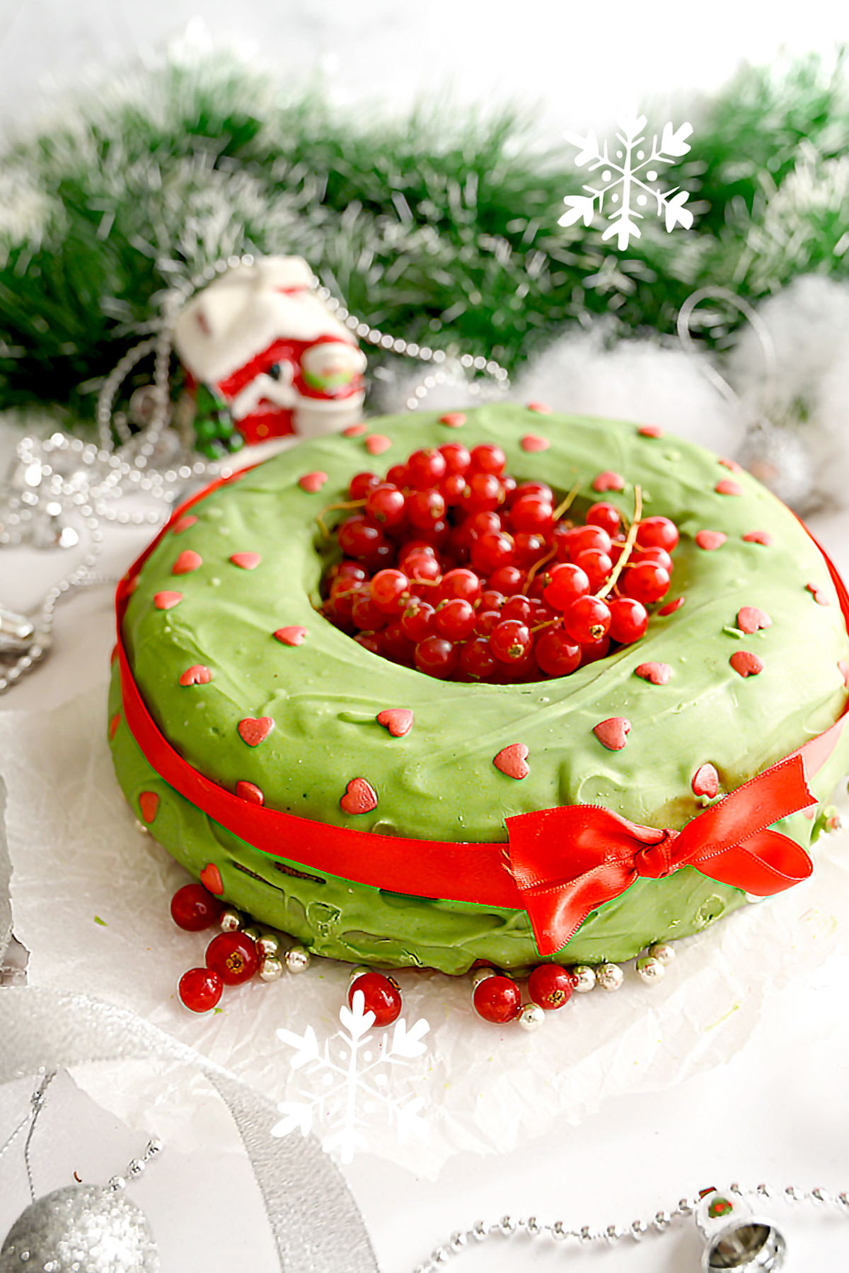 A Christmas cake with a red ribbon tied around it.