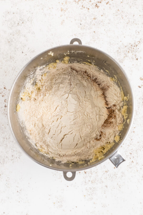 Dry ingredients and wet ingredients in the bowl of a stand mixer.