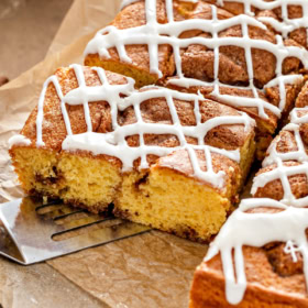 A slice of cinnamon roll cake on parchment paper.