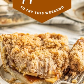 A slice of apple pie on a plate with a fork cutting a bite.