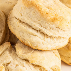 Fluffy 7-up biscuits stacked on a plate.