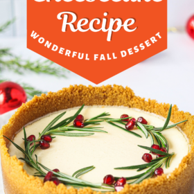 Eggnog cheesecake with a wreath on top made out of rosemary and pomegranate seeds.