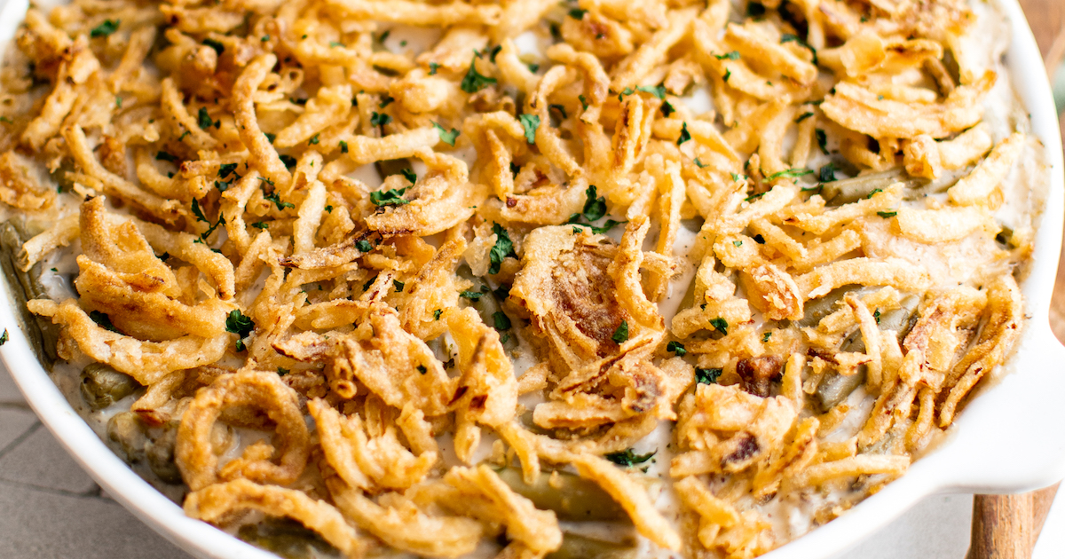 A casserole dish filled with easy green bean casserole with fried onions on top.