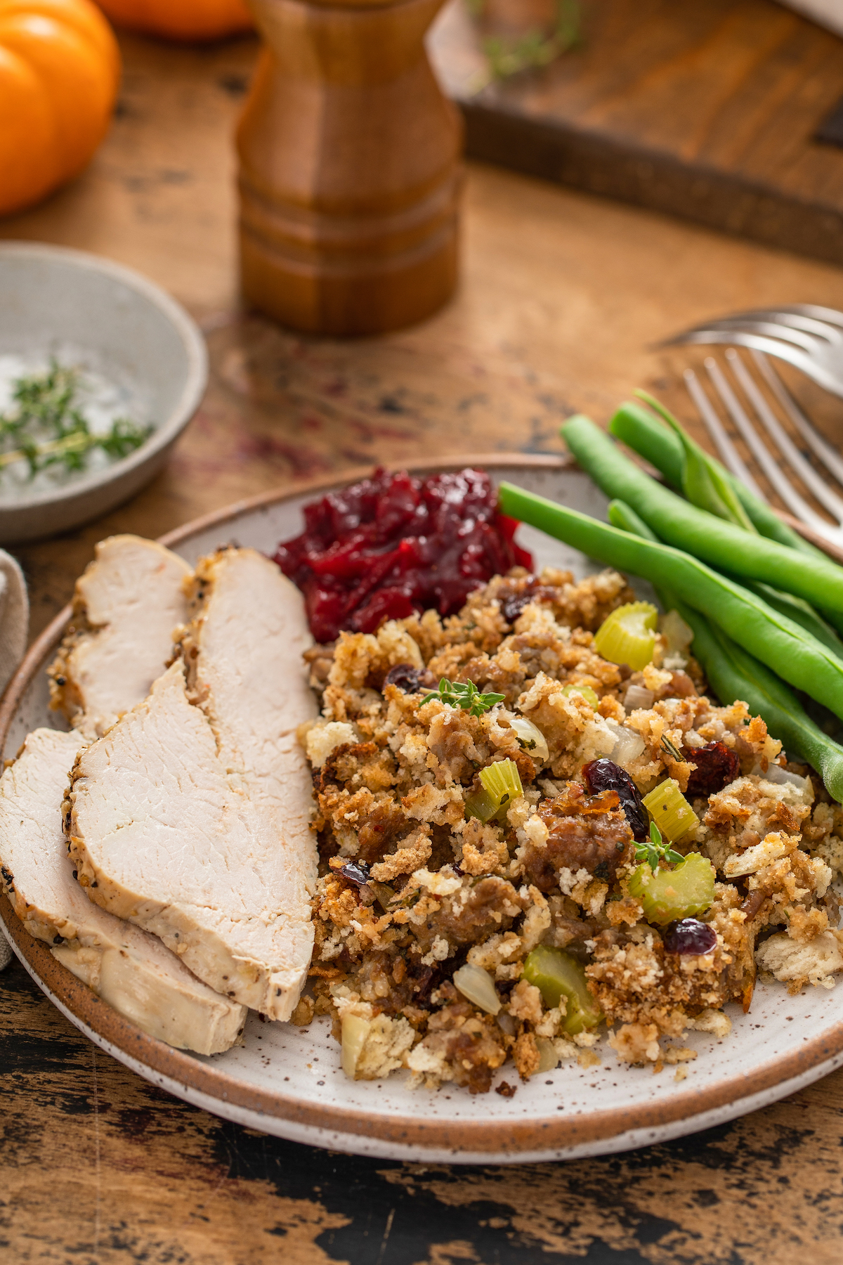 A dinner plate with Thanksgiving turkey and sides.