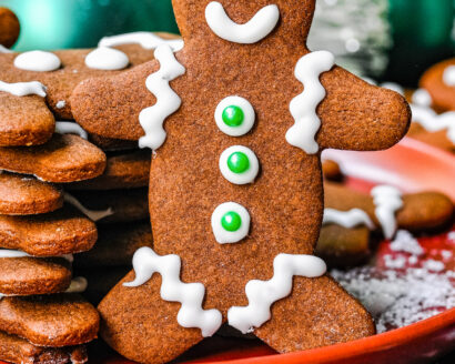 A gingerbread cookie with piped royal icing decorations.