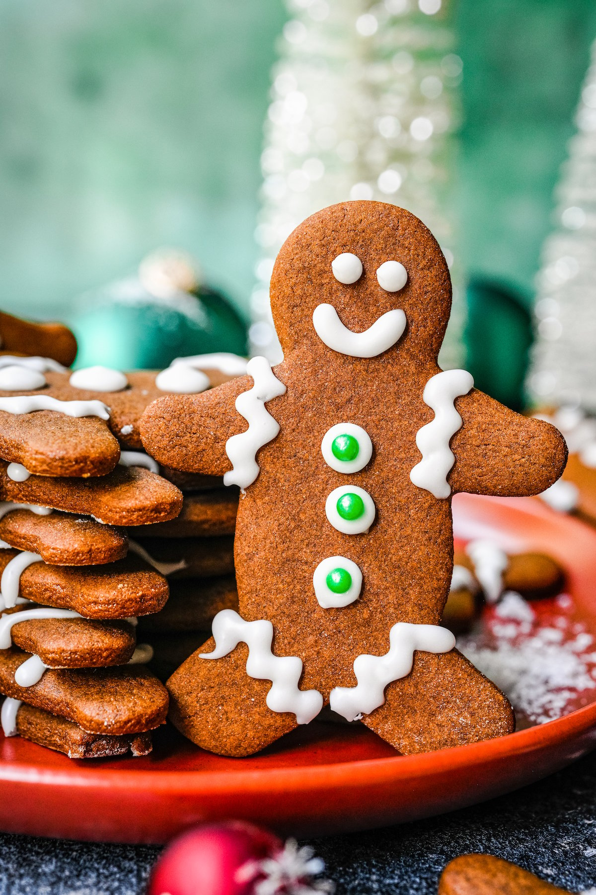 A gingerbread man with icing face, buttons, sleeves, and cuffs.