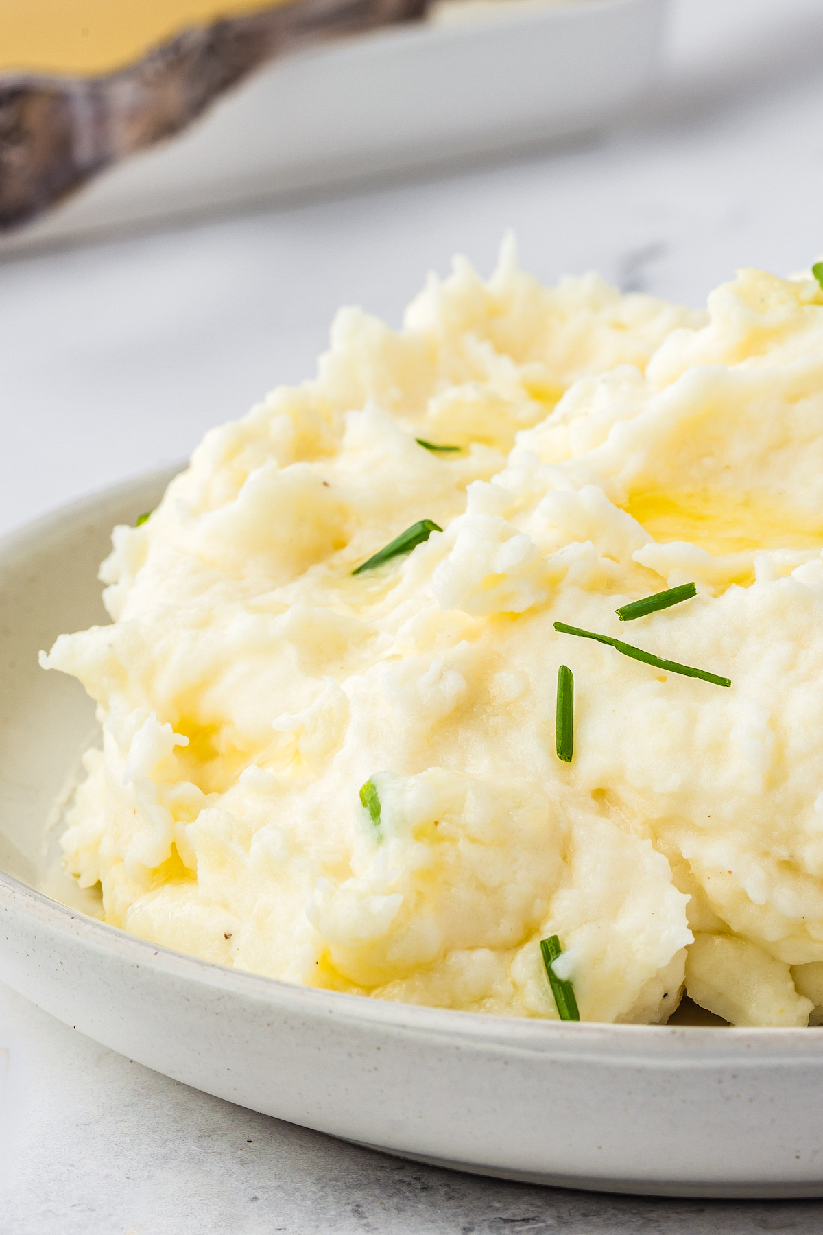 Close-up shot of creamy mashed potatoes with chives.