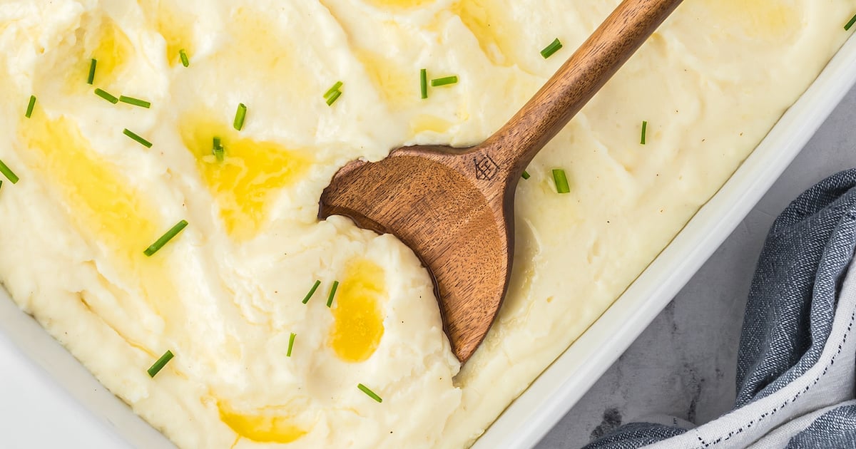 Mashed potatoes topped with butter and chives.