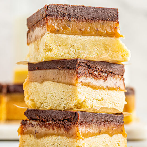 Three millionaire's shortbread bars stacked on top of each other.