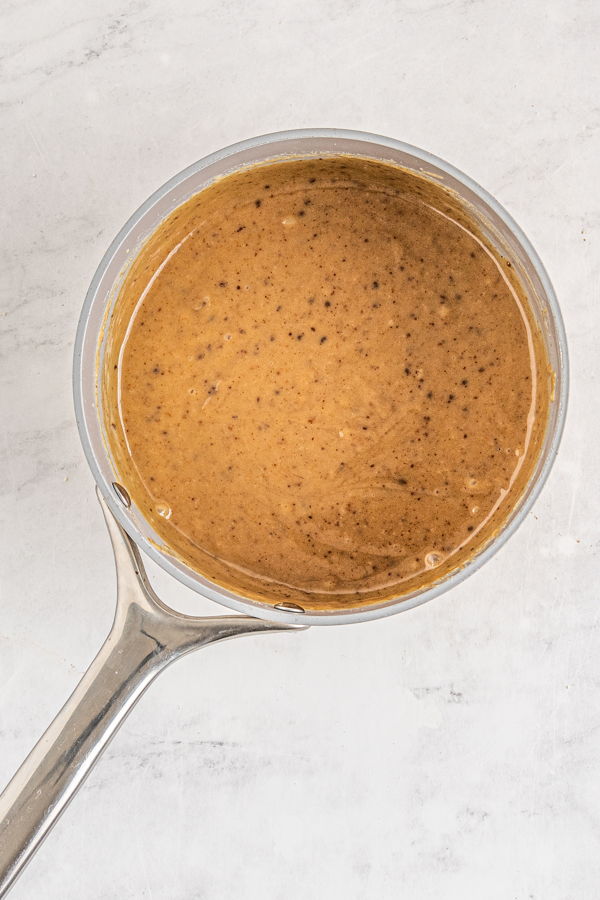 Golden-brown caramel sauce in a saucepan.