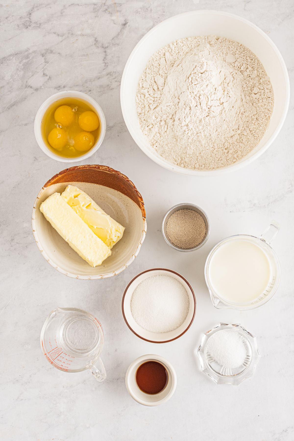 From top: Flour, eggs, butter, yeast, water, milk, sugar, vanilla, salt.