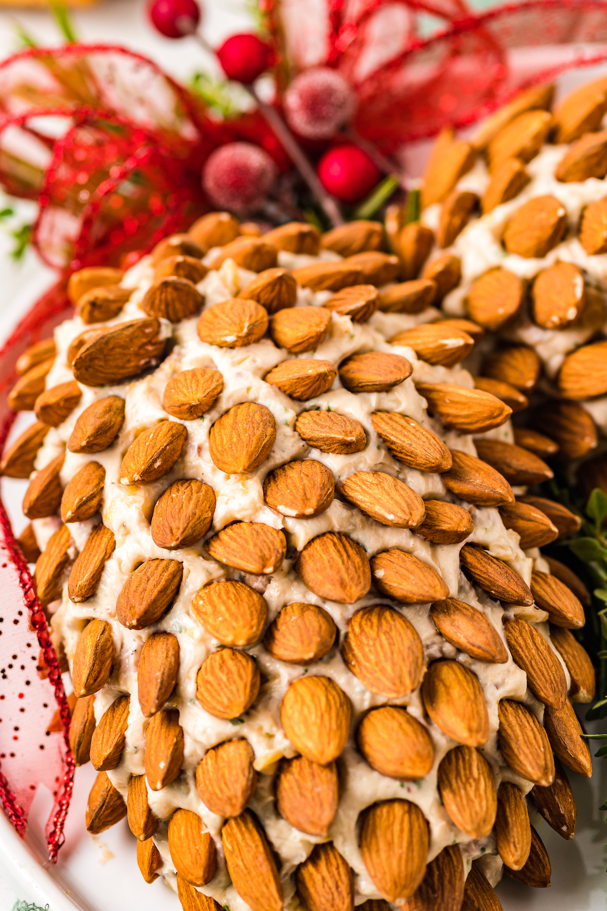 Close-up shot of a cheese ball decorated with whole almonds.