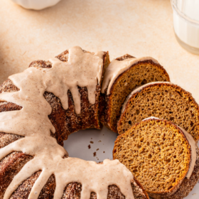Sliced pumpkin bundt cake with icing drizzled on top.