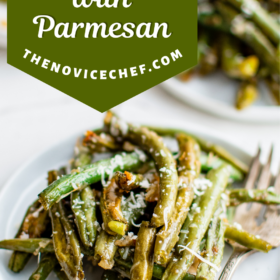 A plate of roasted green beans with shredded parmesan cheese on top.