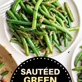 Sautéed green beans on a plate with two forks.