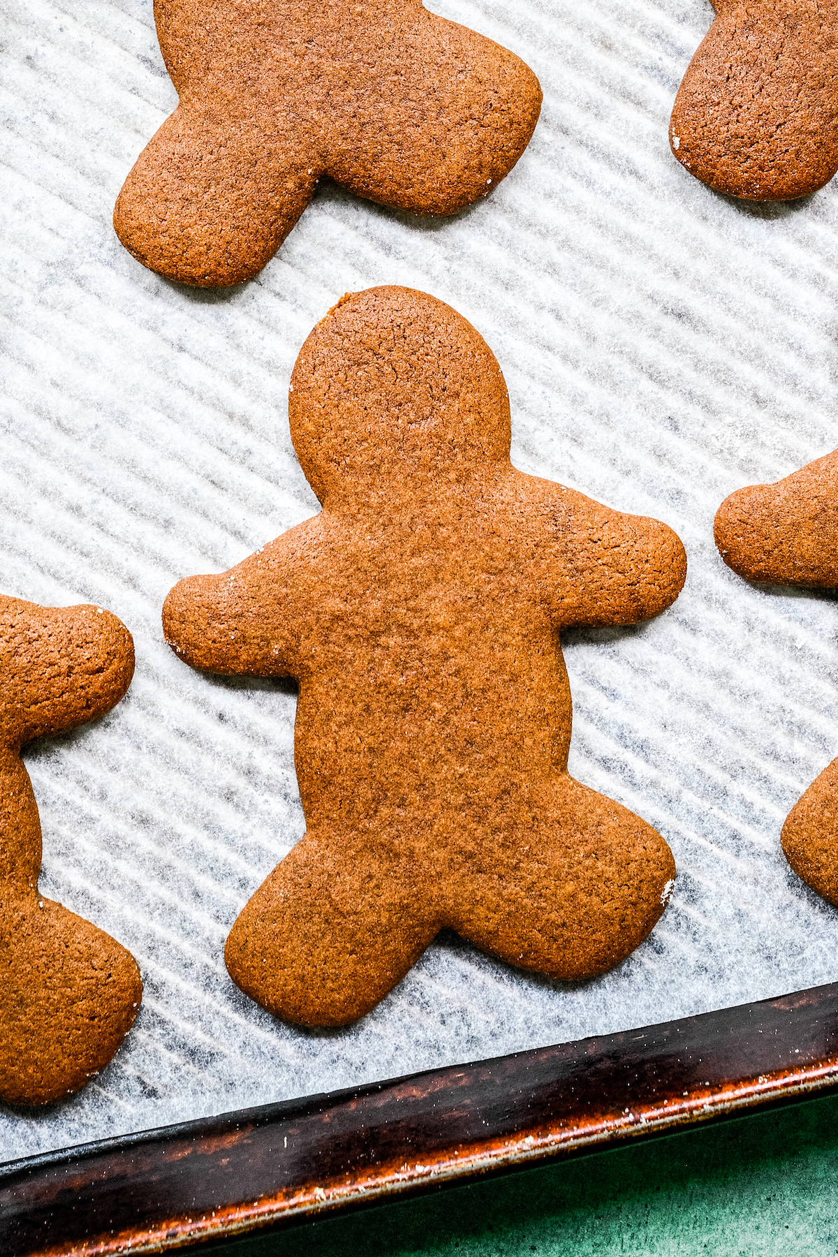 Baked gingerbread men on a cookie sheet.