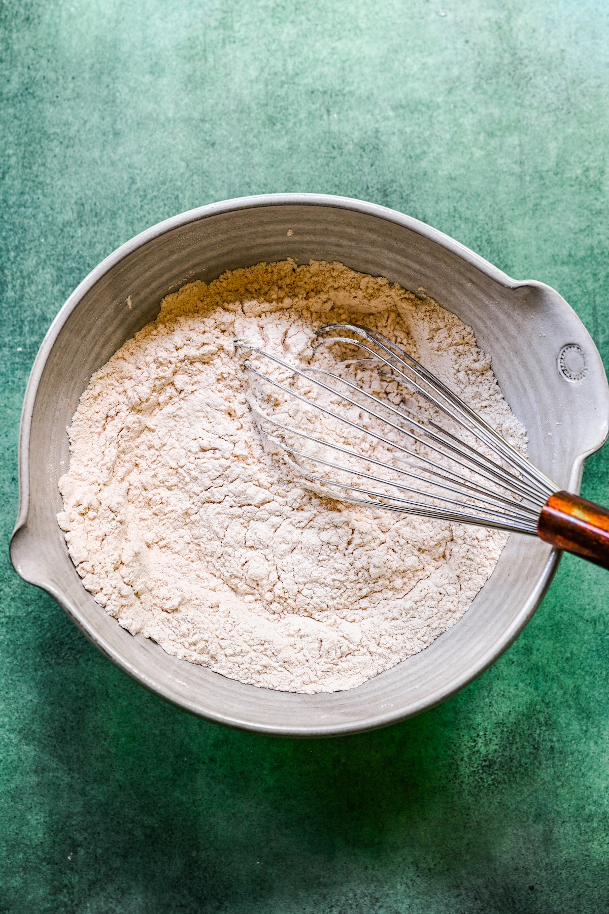 Dry baking ingredients whisked together in a mixing bowl.