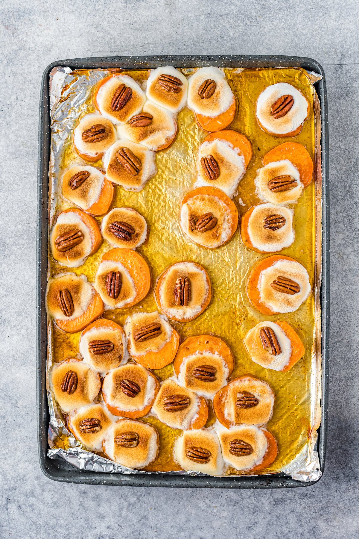Baked sweet potato bites with melted marshmallows and pecans on top.