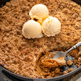 A spoon scooping a serving of sweet potato pie crumble.