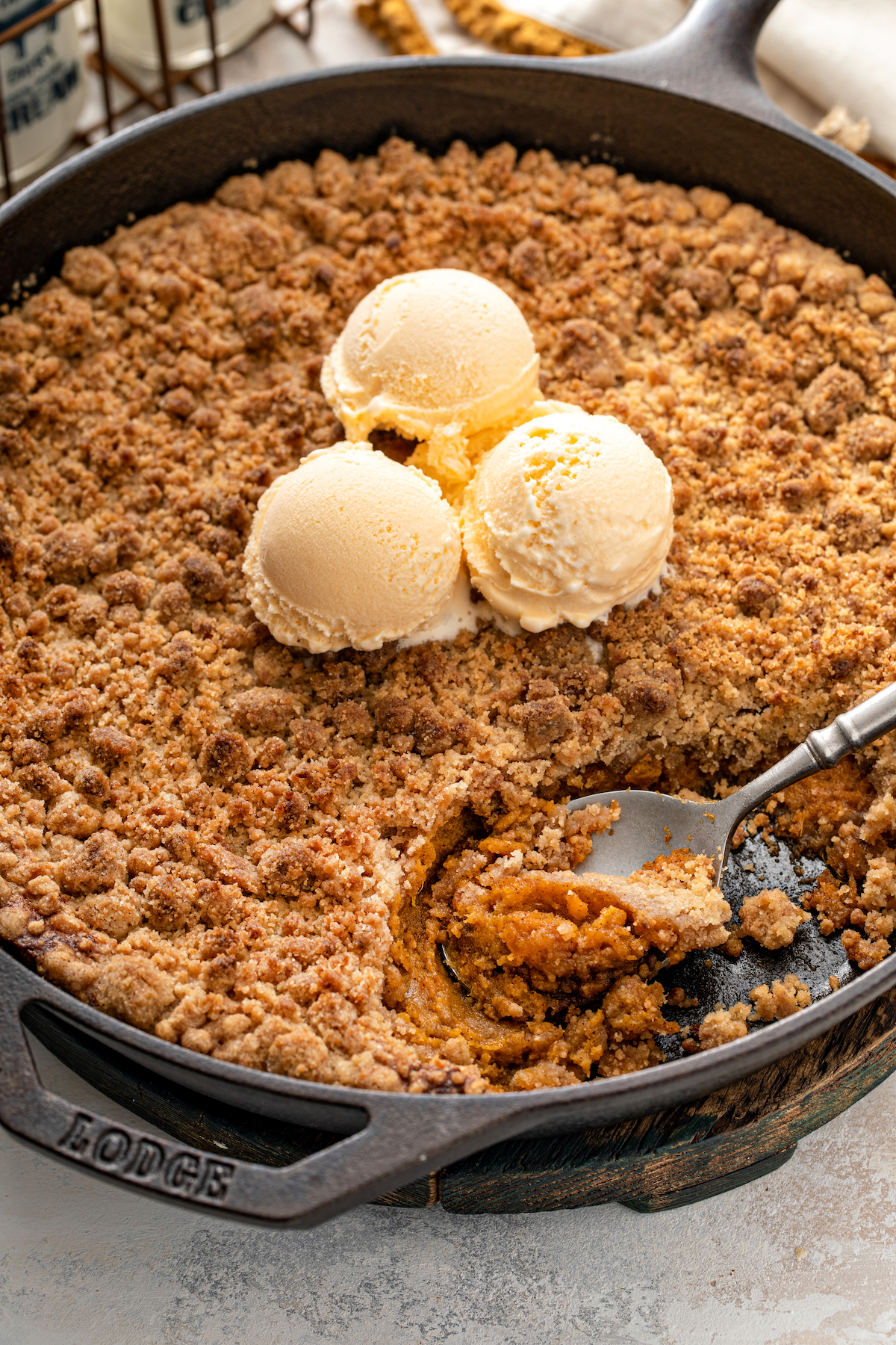 A spoon scooping a serving of sweet potato pie crumble.