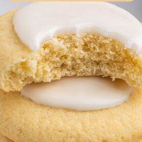 Almond cookies stacked on top of each other with a bite taken out of the top cookie.