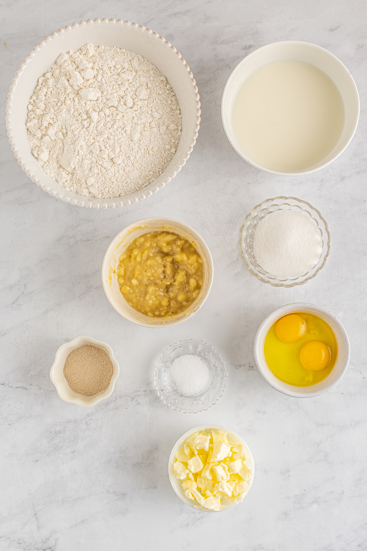 From top left: Flour, milk, brown sugar, white sugar, vanilla, salt, eggs, butter.