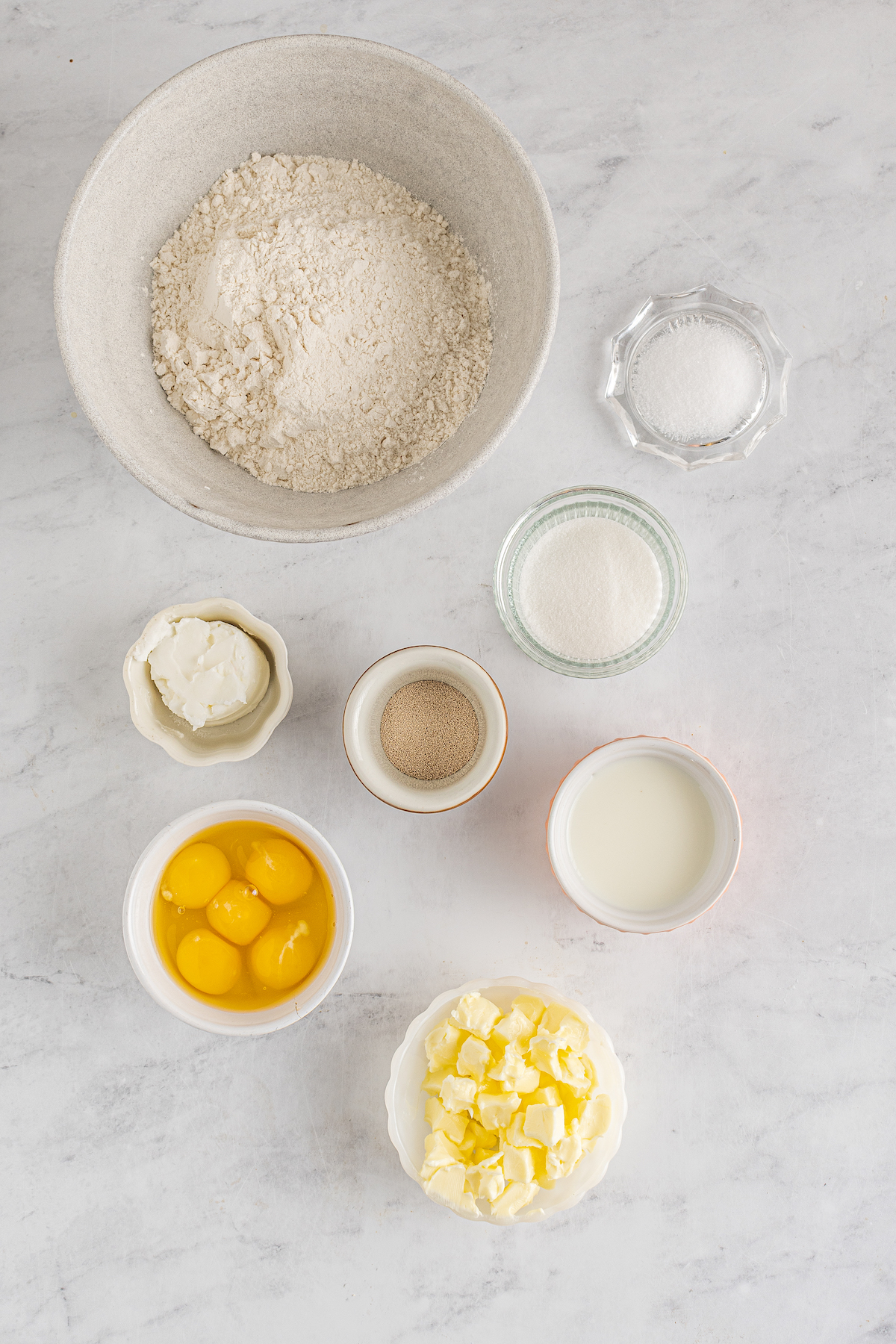 From top left: All-purpose flour, salt, sugar, yeast, milk, shortening, eggs, butter.