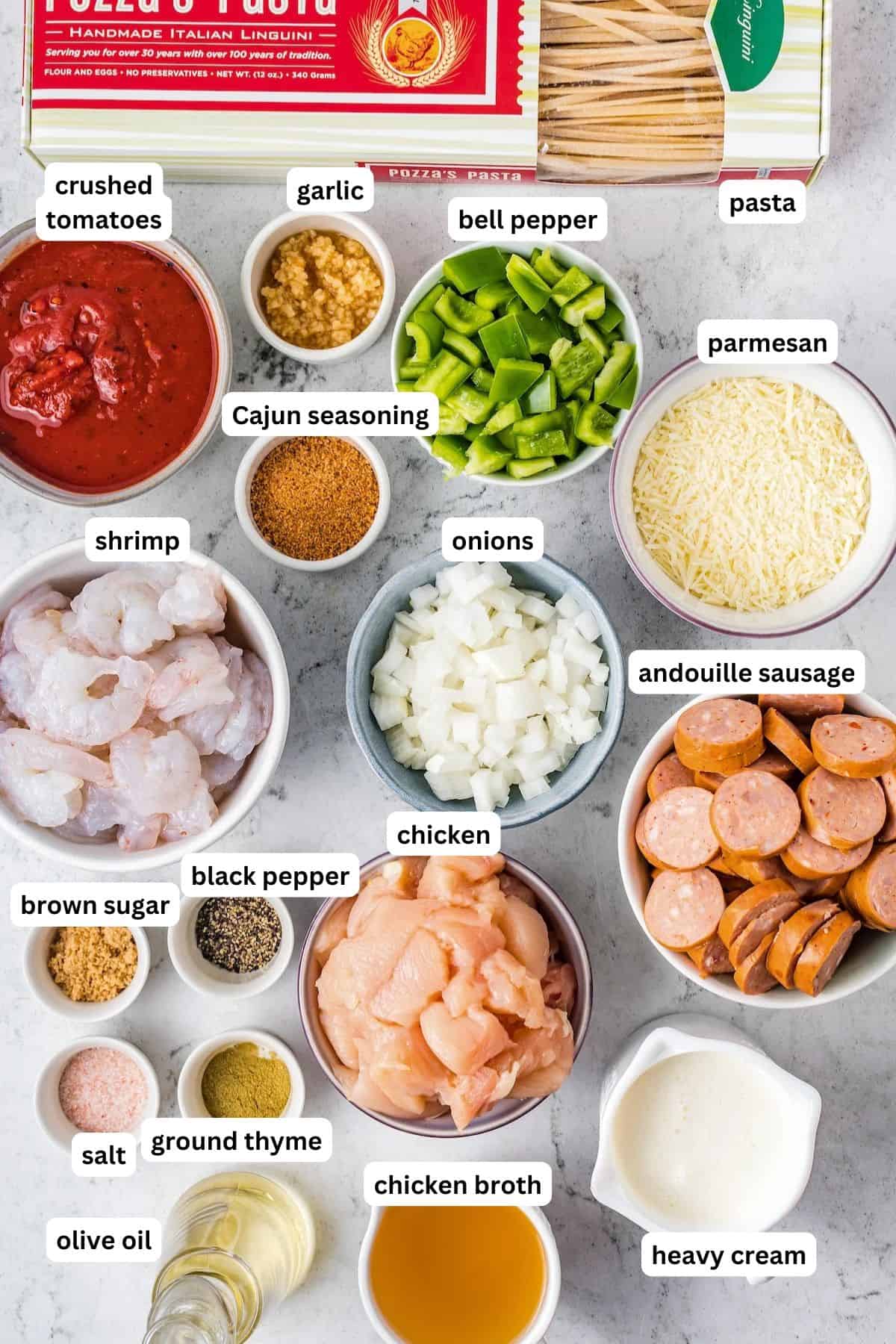 Featuring chicken, sausage, and shrimp, this creamy Cajun Pasta recipe is tossed in a creamy and spicy sauce with tender linguine pasta. An assortment of ingredients in bowls for this Cajun pasta recipe. From top to bottom: pasta, crushed tomatoes, garlic, bell pepper, parmesan, shrimp, Cajun seasoning, onions, andouille sausage, chicken, brown sugar, black pepper, salt, thyme, broth, olive oil, and cream.