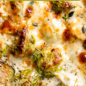 Brussel sprouts covered in cheese in a baked dish.