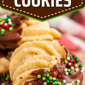 Butter cookies dipped in chocolate with red and green sprinkles.