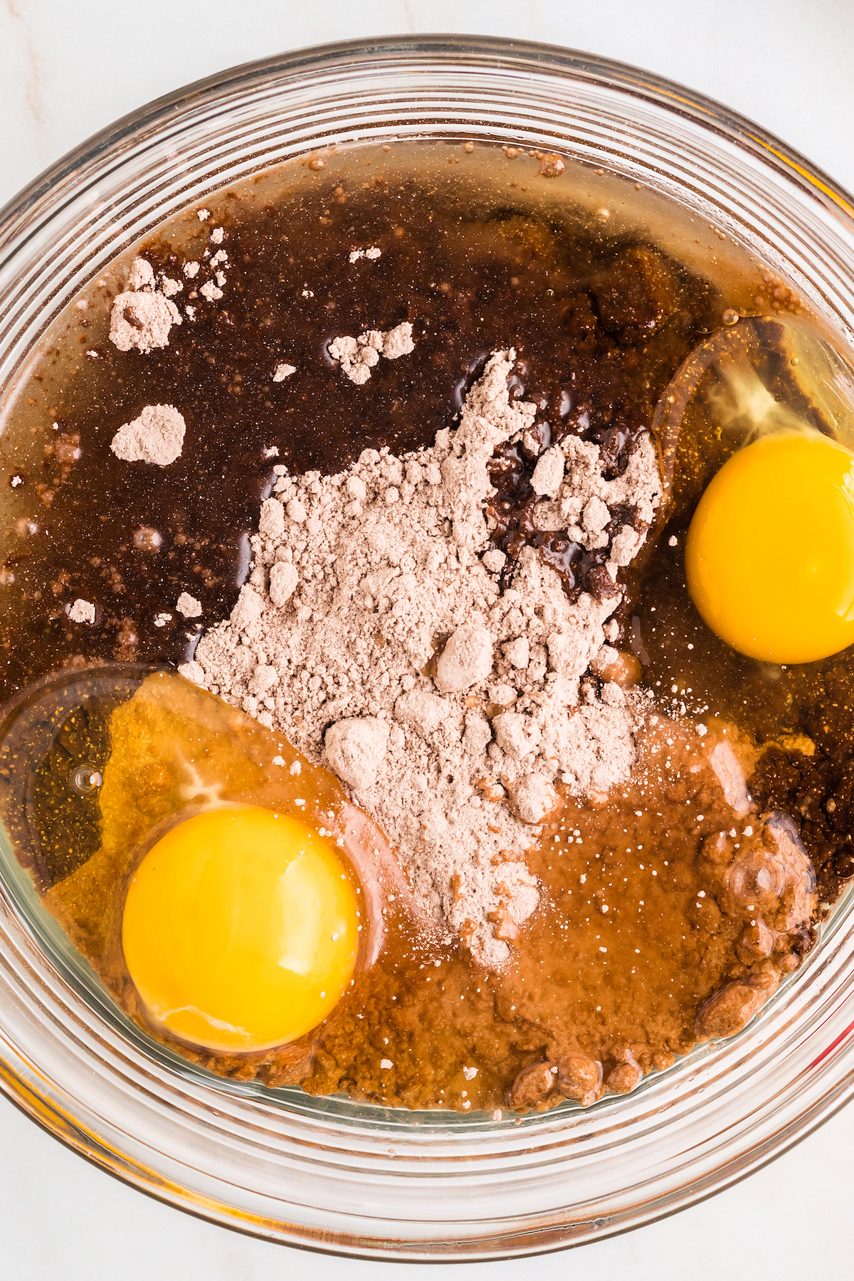A mixing bowl with cake mix, eggs, and oil.