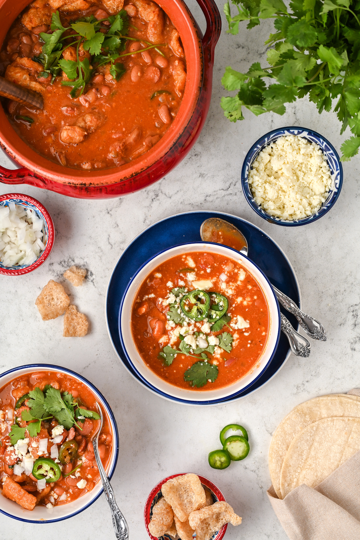 Frijoles charros in a bowl, topped with cilantro, jalapeño, and cilantro. 