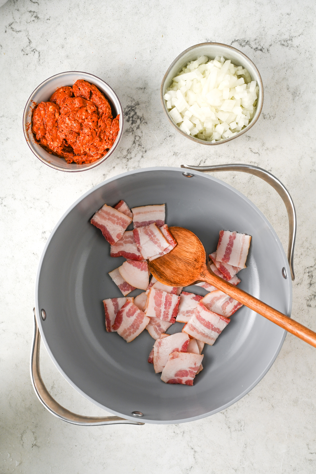 Cooking the bacon in a pot. 