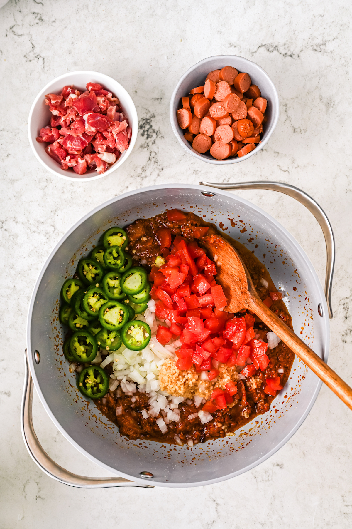 Cooking the tomatoes, onion, jalapeño, and garlic in the pot.