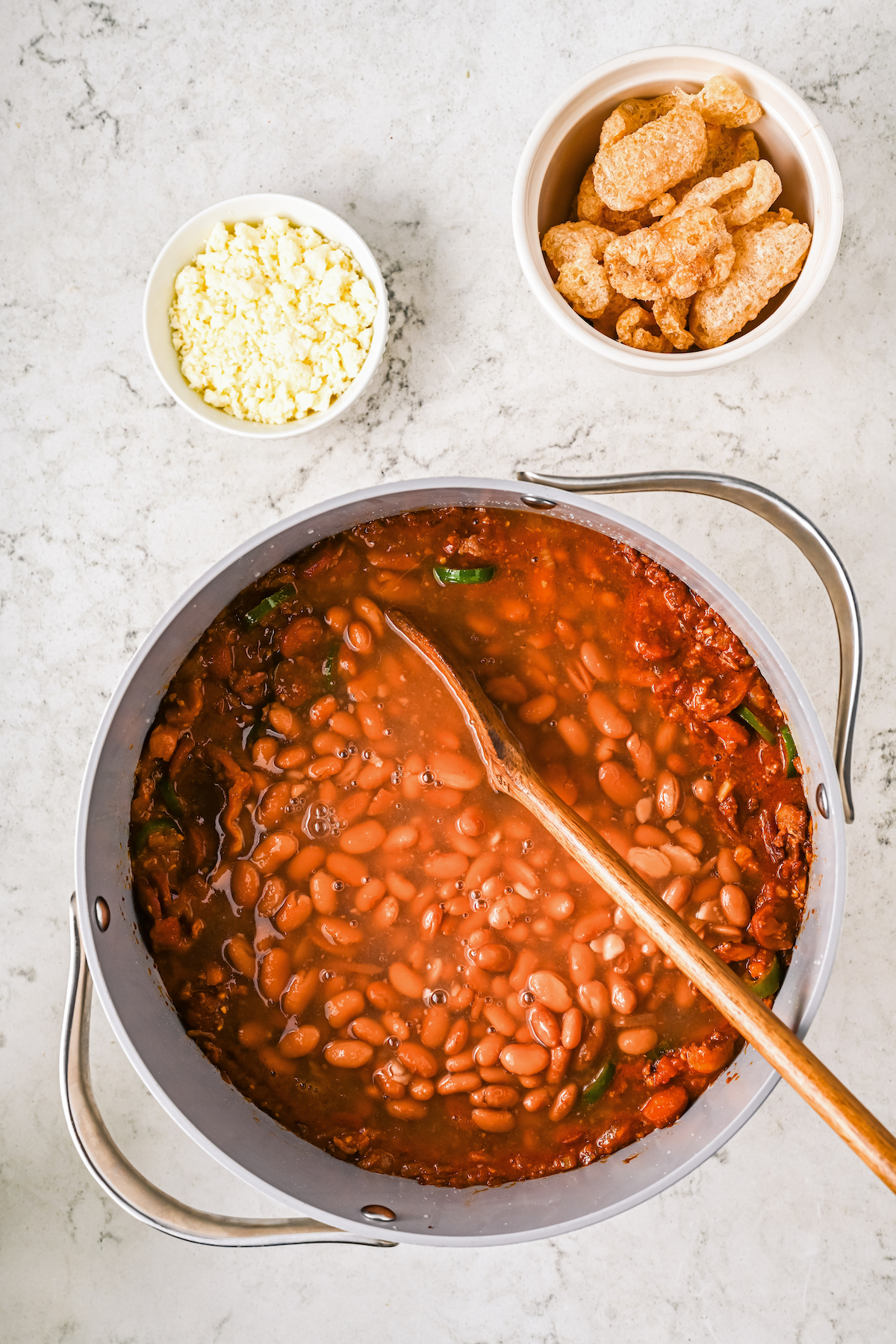 Adding the beans and bean broth to the pot. 