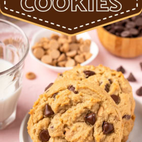 Two peanut butter cookies with chocolate chips stacked on a plate.