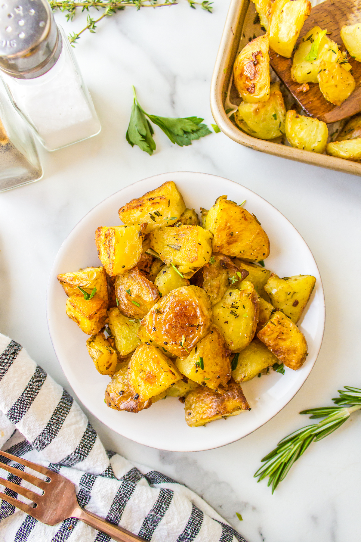 A plate with a helping of crisp herbed potatoes.