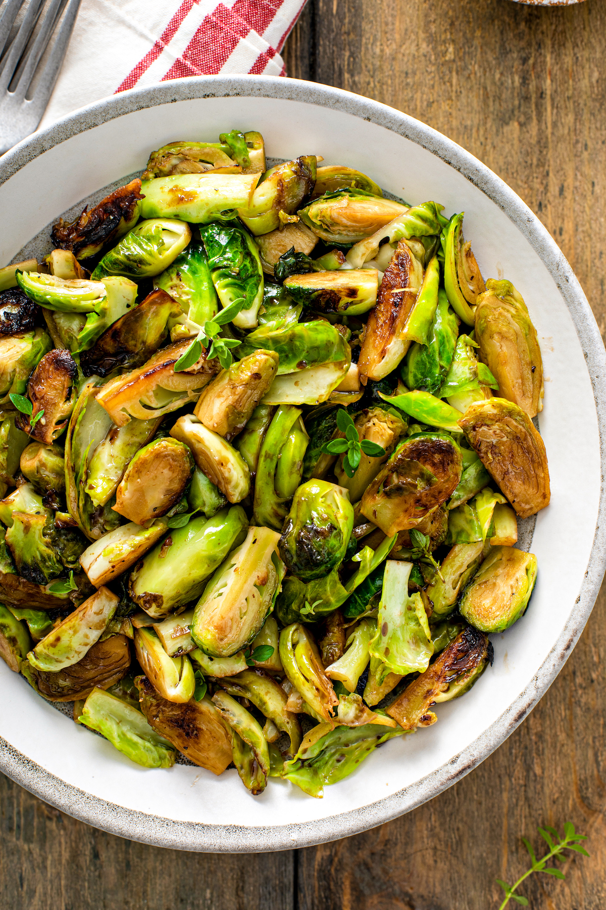 Sauteed brussel sprouts with balsamic glaze in a dish.