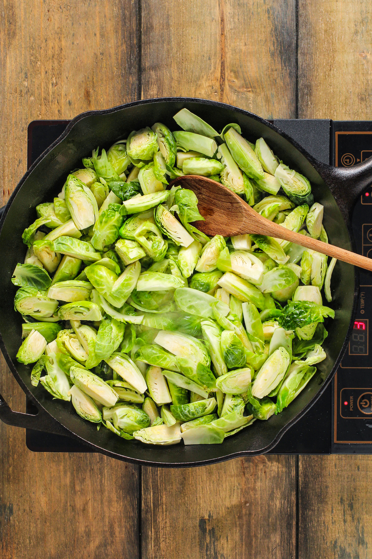 Sauteeing sprouts in a skillet.