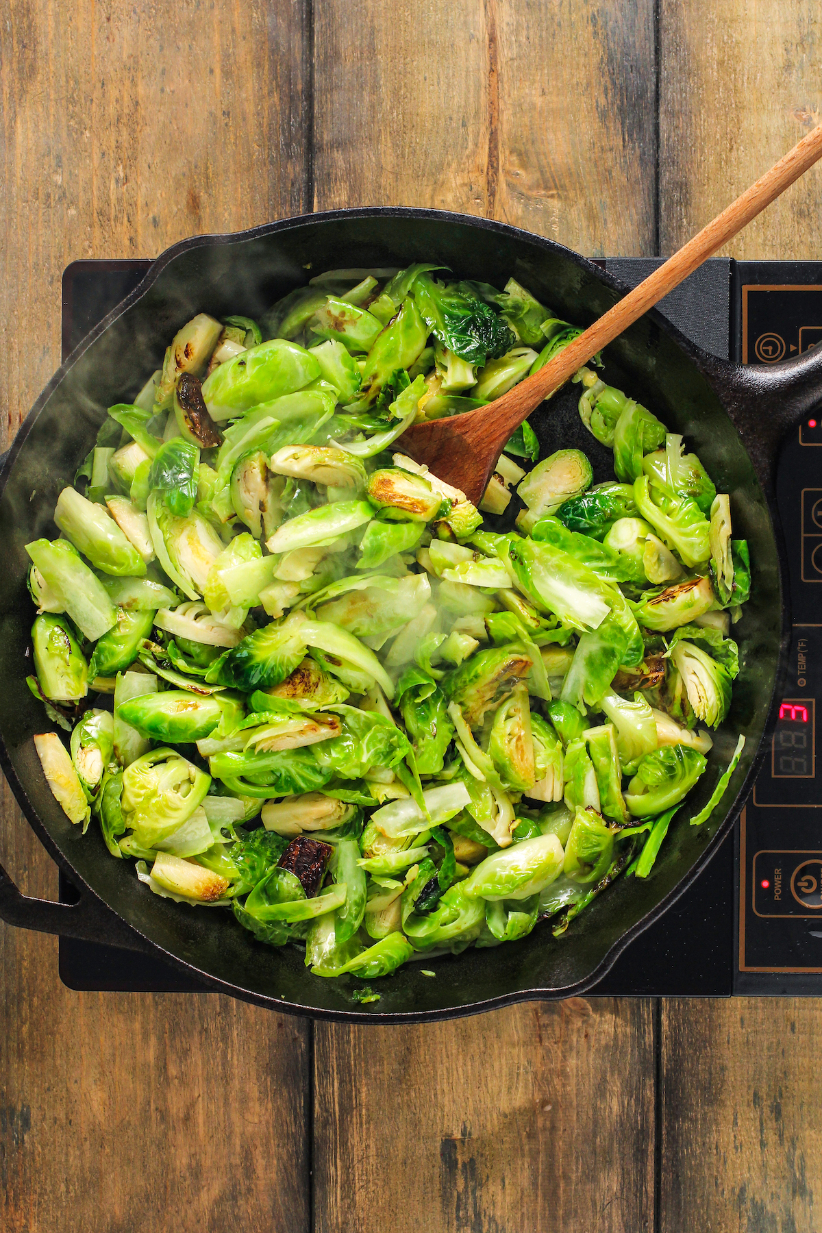 Brussels Sprouts cooking in a skillet.
