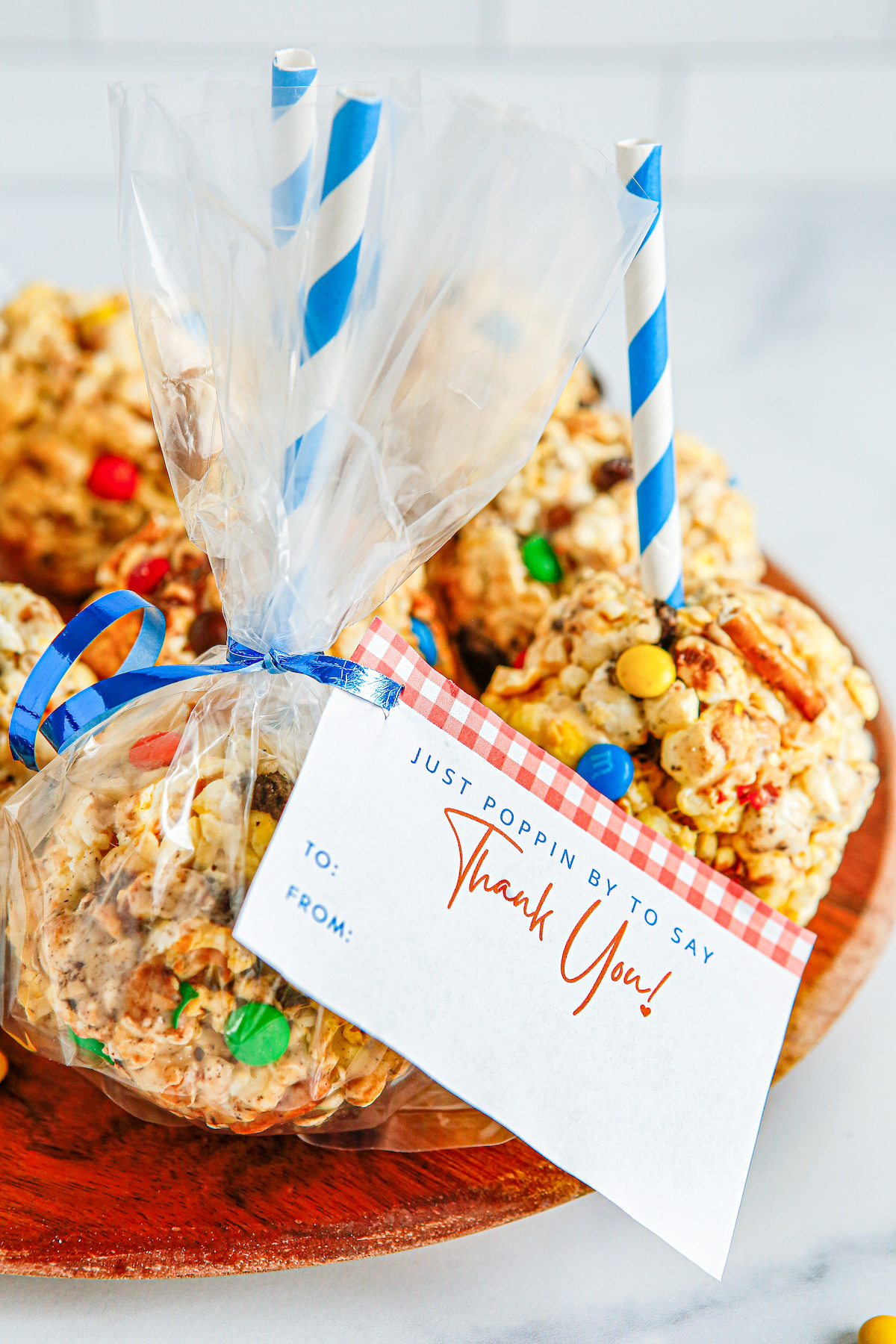 Popcorn treats wrapped in cellophane and tied with ribbons and gift tags.