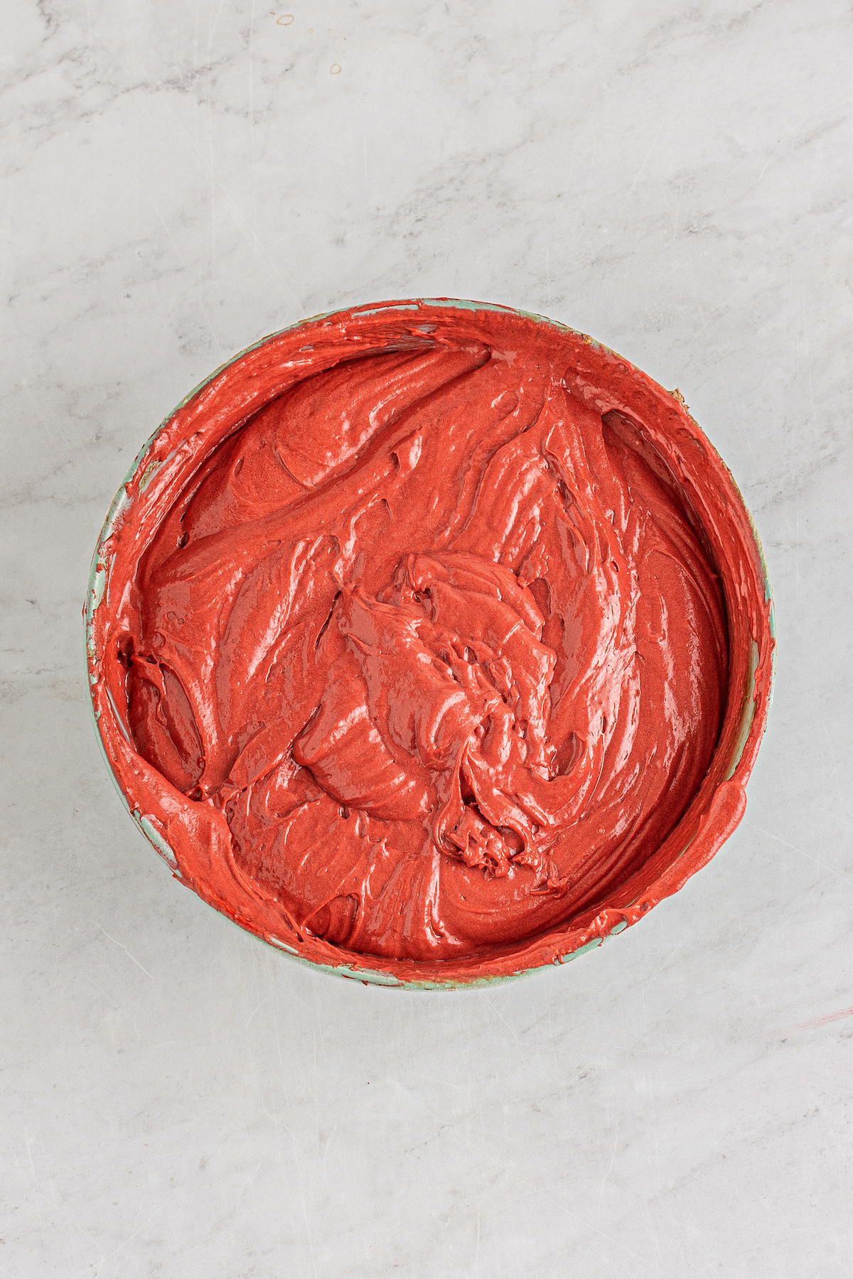Red batter in a mixing bowl.