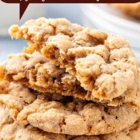 Cookies stacked on top of each other with the top cookie broken in half.