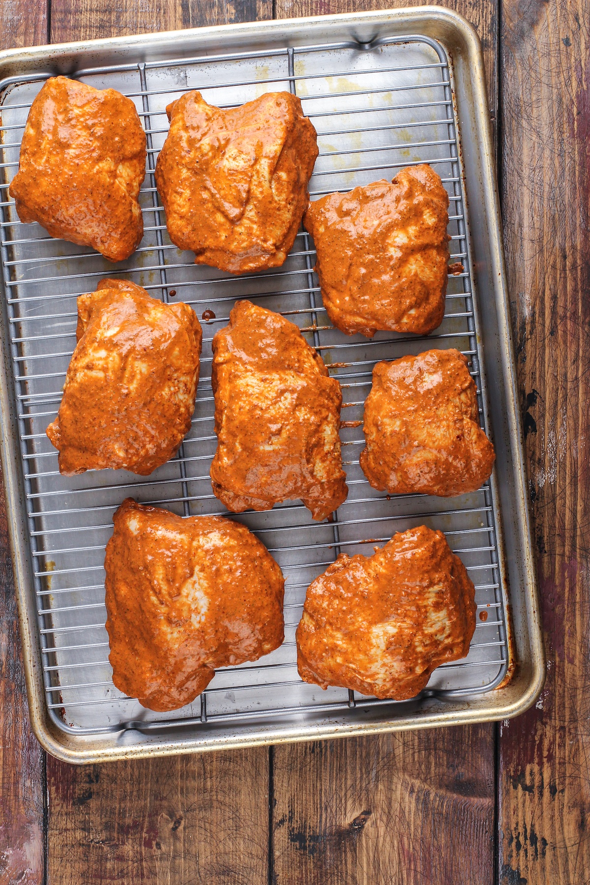 Resting the chicken at room temperature before grilling.