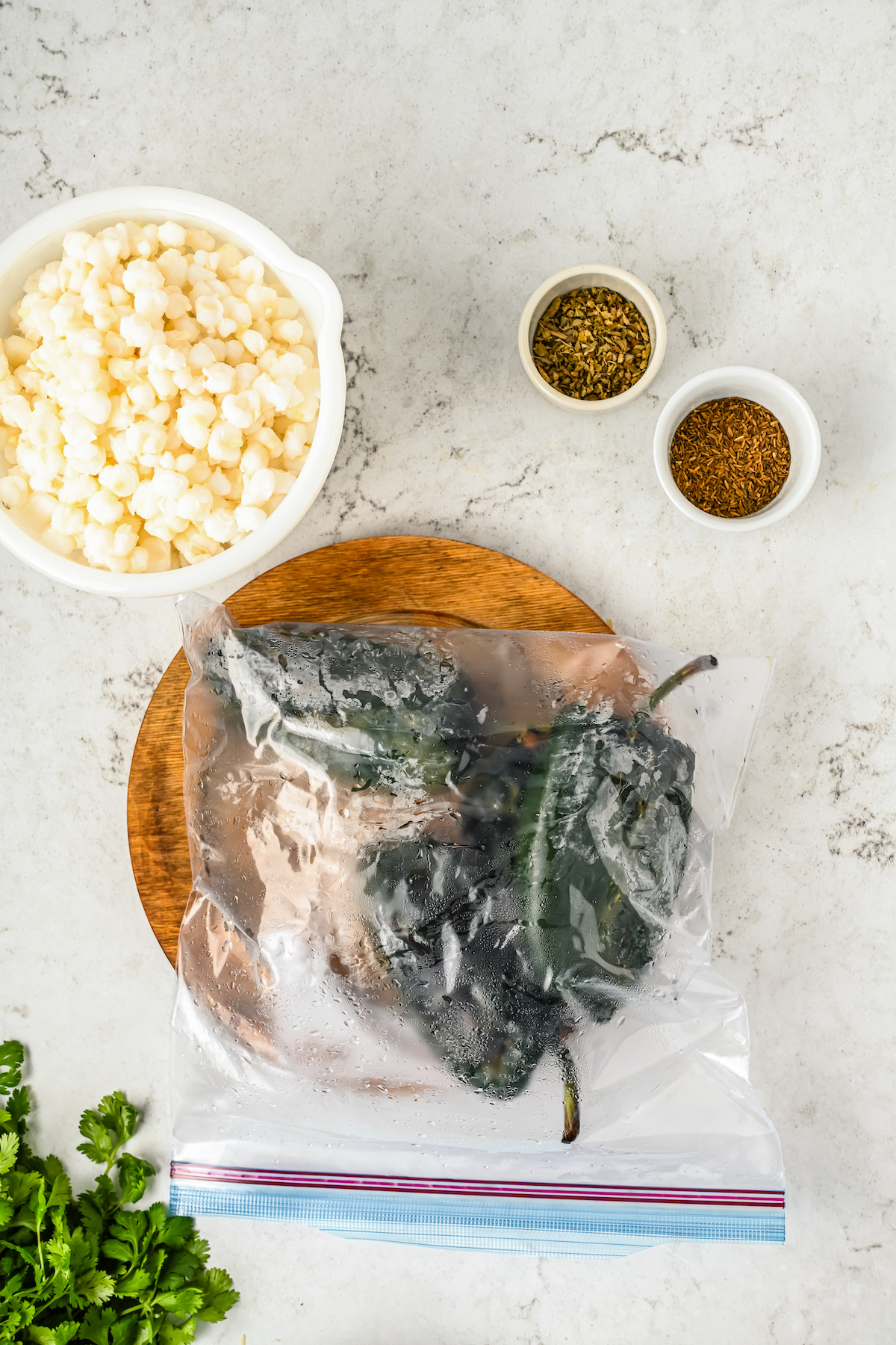 Charred poblano peppers in a sealed ziplock bag.