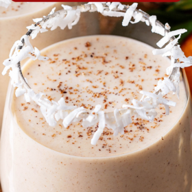 Coconut eggnog in a glass with spices on top.