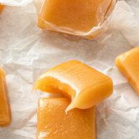 Caramels stacked on top of each other with a bite taken out of one.