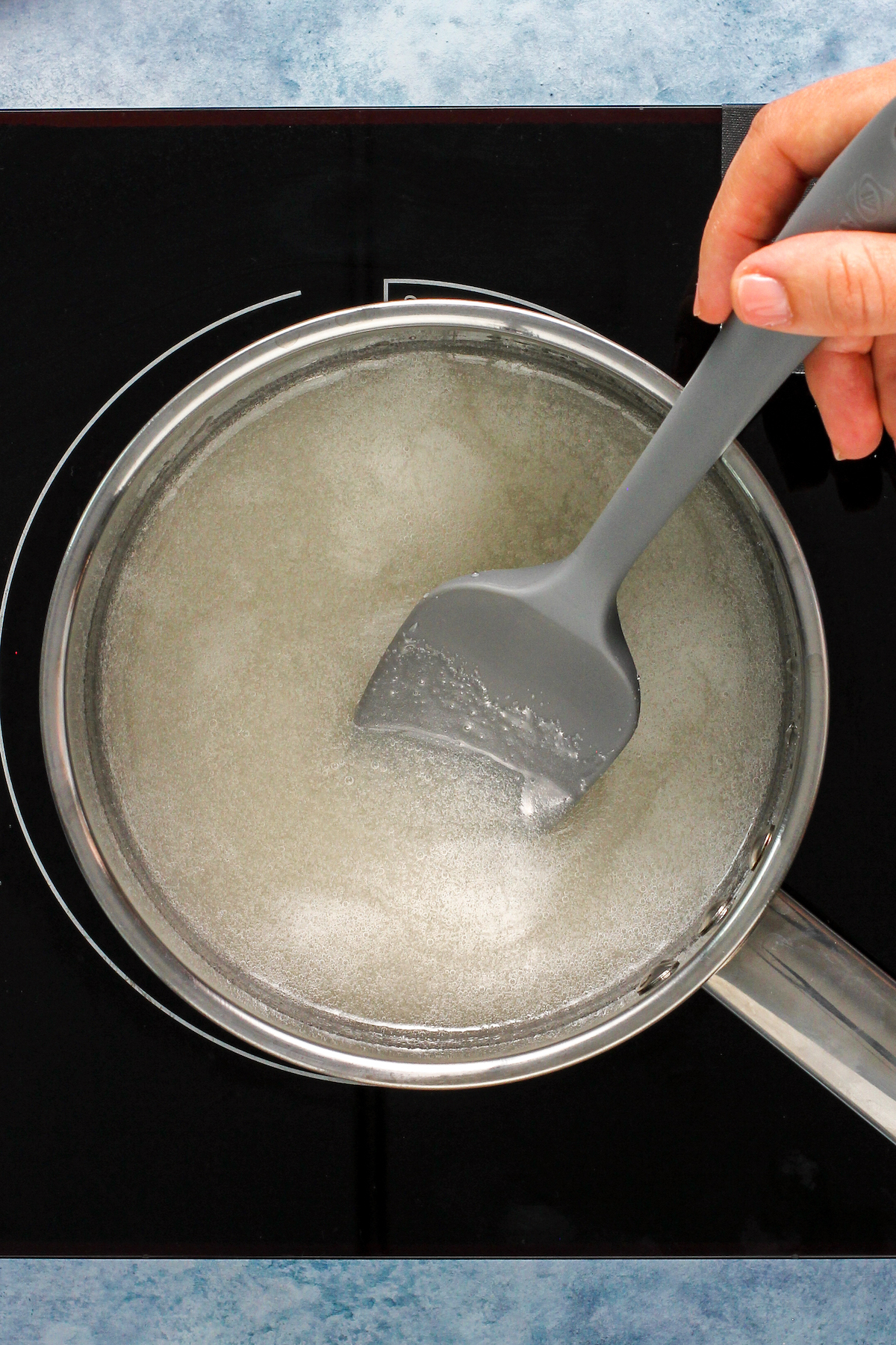 Sugar mixture cooking in a sauce pan.